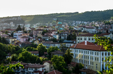 Fototapeta na wymiar Beautiful view over the old town with a traditional architecture of Veliko Tarnovo on a summer day at sunset. Bulgaria