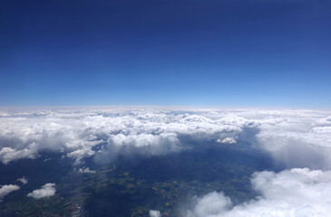 Fototapeta na wymiar Beautiful sky landscape with view from the aircraft above dense white clouds high in the stratosphere on a sunny day horizontal photo