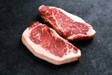 Fototapeta na wymiar Raw New York striploin beef steak isolated on black background