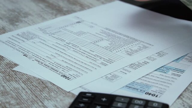 Filling 1040 Tax Form and Taxes Document on Table in Office. Individual Income Tax Return. Tax payment time Concept