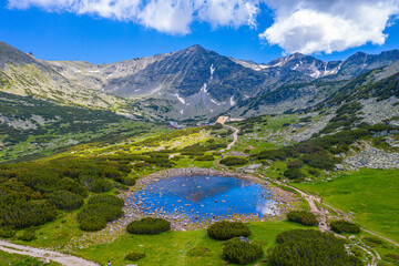Musala peak mirroring at a surface of a mountain lake in bulgaria