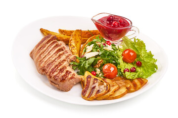 Grilled beef steak with potato wedges, grilled pears and arugula salad with feta cheese, isolated on white background