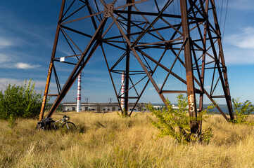 Large iron power pole. Bicycle by the pole. Bikepacking by bike.