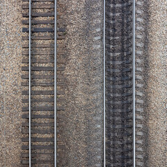 Two parallel railroad tracks from old wooden sleepers and new concrete sleepers on rubble base....