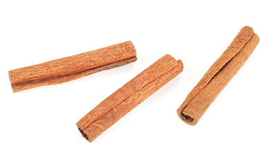 Three cinnamon sticks isolated on a white background, top view.
