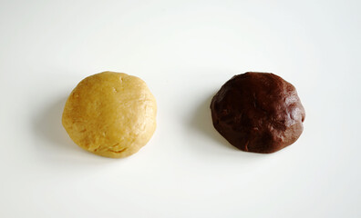 two pieces of dough on a white table 