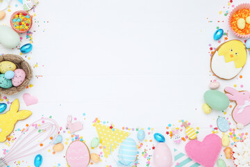 Easter gingerbread cookies with candies on white wooden table