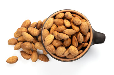 Almonds in a ceramic bowl on a white background, top view