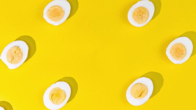 Eggs moves on the yellow background - Stop motion animation - Seamless pattern with eggs	