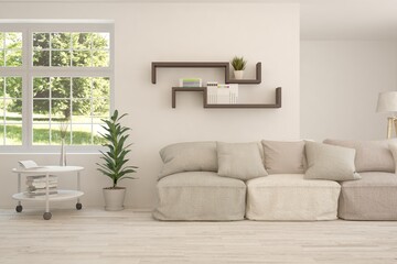 Obraz premium White living room with sofa and summer landscape in window. Scandinavian interior design. 3D illustration