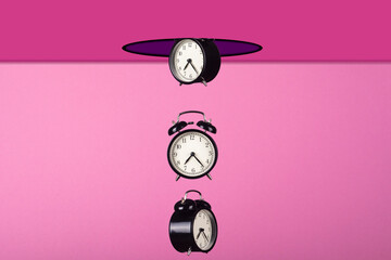Creative composition. Alarm clocks fall from a hole in the ceiling.