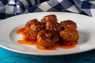 Meatballs in a white plate close-up.