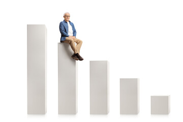 Smiling mature man sitting on a graph chart and looking at camera