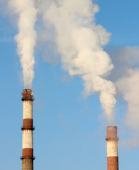 smoke from a chimney against a blue sky.