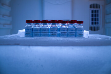 pool of covid 19 vaccines in a block of ice for preservation and transport - Powered by Adobe
