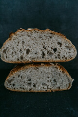 Close up or detailed view of freshly baked sourdough bread, dark background.