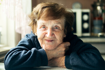 Portrait of an happy old woman in her home.