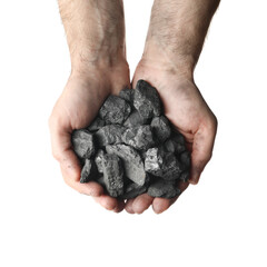 Man holding coal in hands on white background, top view