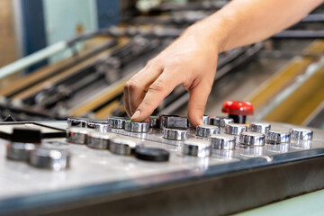 close up engineer hand finger press button controling cnc machine, Workers operating factory machinery in warehouse
