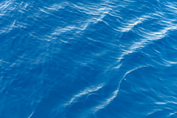 Sea surface. Blue water texture. Close up blue water surface at deep ocean