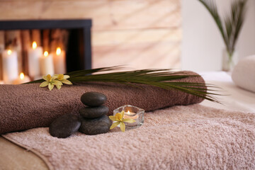Beautiful spa accessories on massage table in room