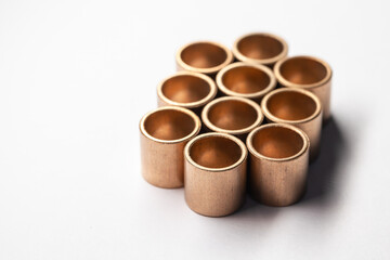 Group of sleeve bronze bearings on a white
