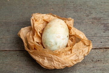 Easter eggs on crumpled paper on a wooden table