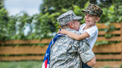 Happy reunion of soldier with family outdoors