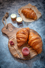 Fresh homemade croissants on textured background