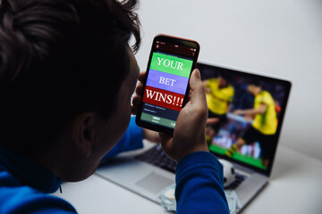 Lucky man celebrating victory after winning jackpot in online bet.