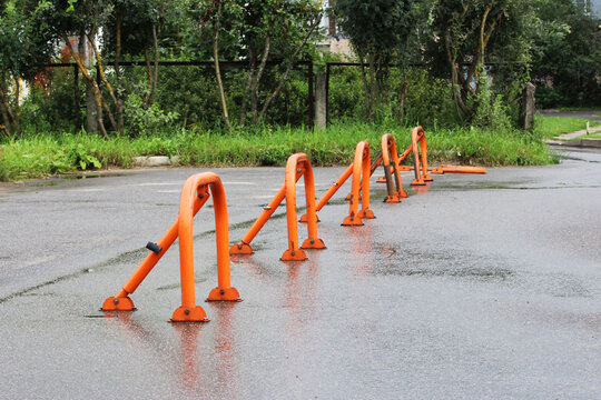 orange parking barriers, parking space limiters and blockers. Parking and road equipment