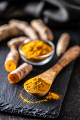 Indian turmeric powder and root. Turmeric spice. Ground turmeric.