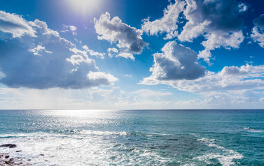 Sun shining over a cloudy sky in Alghero coastline