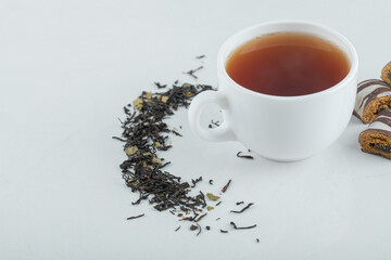 A cup of aroma tea with dried loose teas
