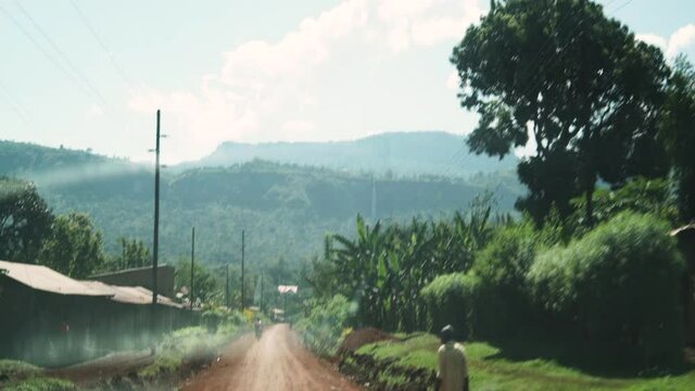 Driving through a village in Uganda, handheld and anamorphic