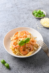 Italian pasta fettuccine with shrimps on gray table. Vertical shot.