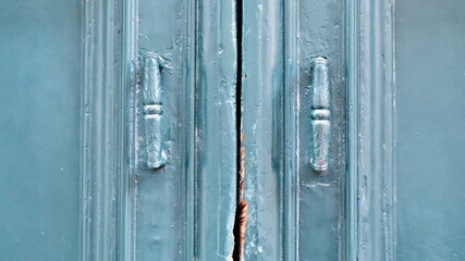 The old vintage green wooden door on the facade of the baroque Dominican Cathedral