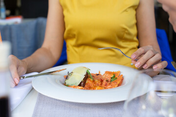 Close up attractive woman hand holding fork and knife, eating lunch