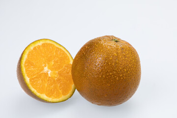 Citrus fruit (rangpur) with water drops isolated on white background