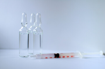 Medical ampoules and insulin syringe isolated on white background, vaccination concept