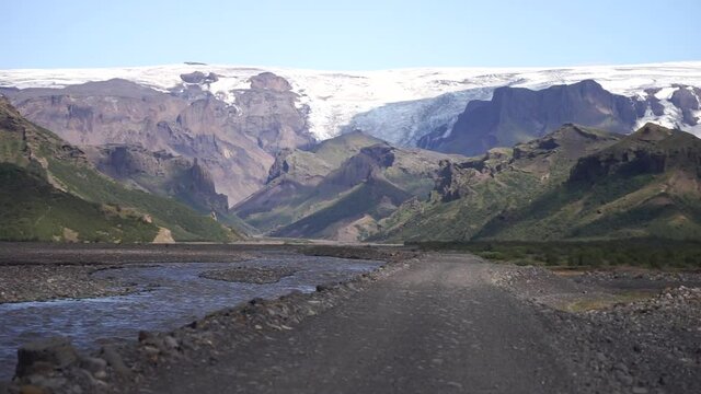 Scenic view Of Mountain Road Among Snowy Mountains nearby river in Thorsmork, Iceland