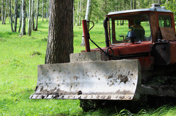 tractor works in the park, leveling the tracks. reportage shooting