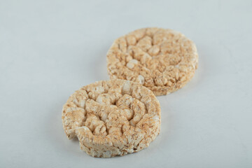 Tasty round crispbread on lighht gray background