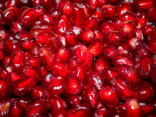 Pomegranate seeds background. Red ripe pomegranate seed closeup. Fruit texture. Healthy food theme.