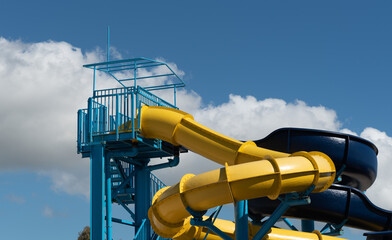Empty water Park twisted water slide amusement resort for children and family vacations on a tropical day