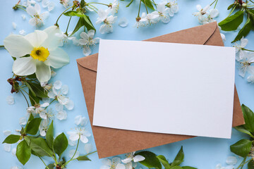 greeting card mockup made of spring flowers, gift box, envelope and white blank for text 