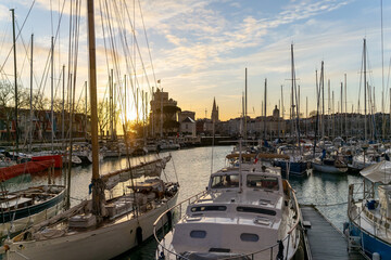 Colorful sailboats at sunset in the old harbor of La Rochelle France 