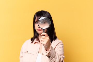 plus size pretty woman looking with a magnifying glass