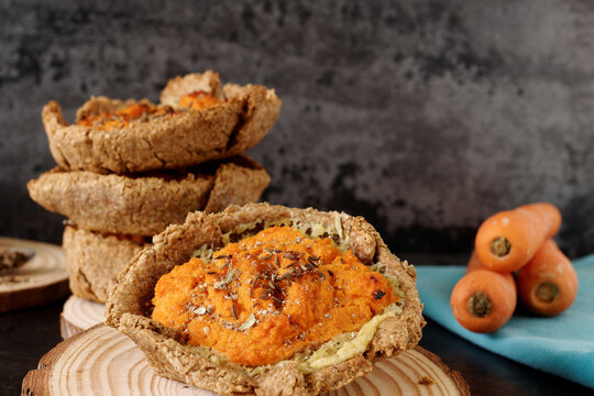 Pie with carrot and potato filling with caraway seeds. Rye flour homemade pastry.