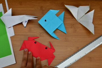 Folding paper origami fish, fox, butterfly  and crab
